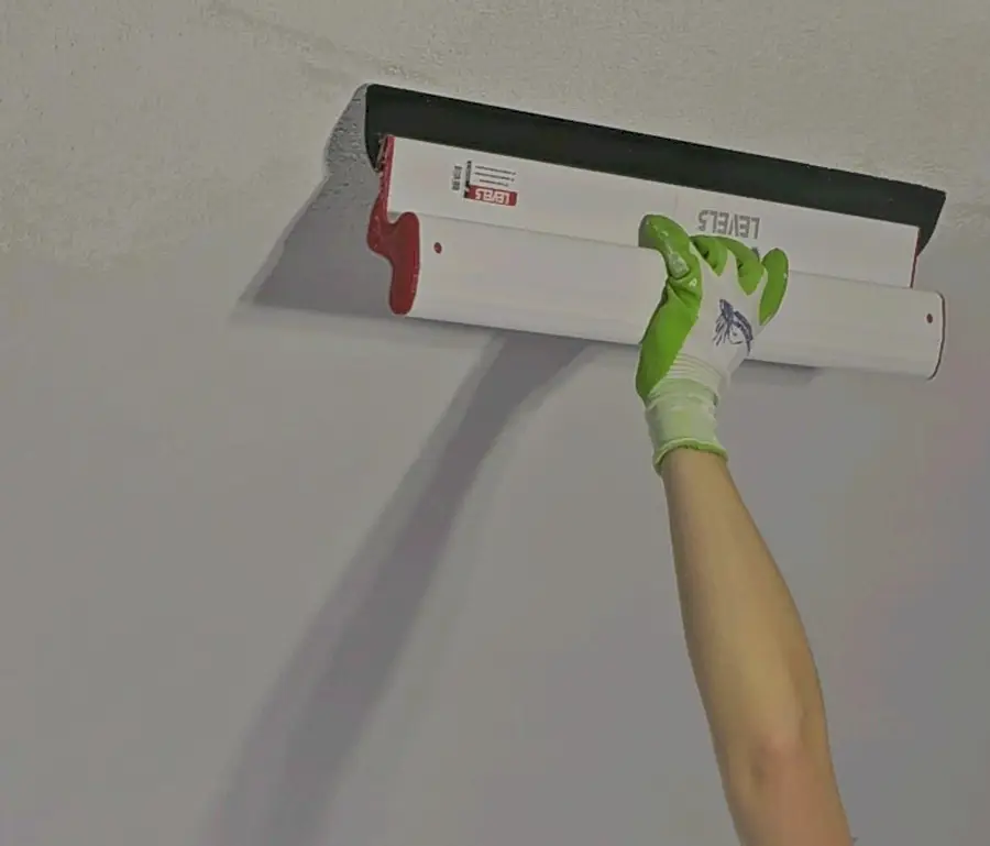 Wall repair and repaint in a high-end modern kitchen.