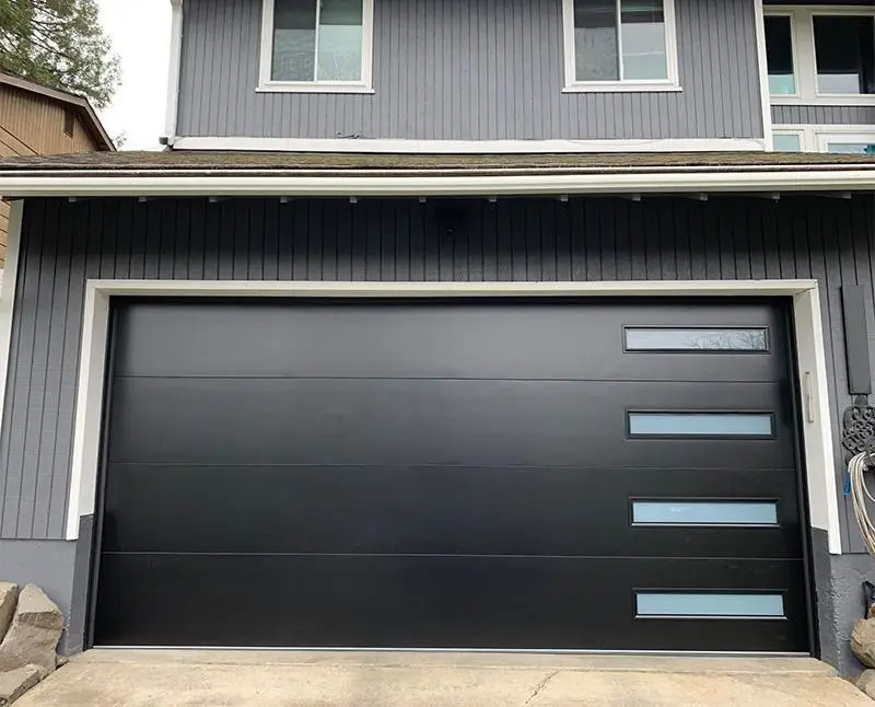 A full aluminum and glass garage door opening to a bright, spacious garage interior.