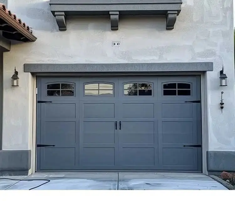 A textured-panel garage door in dark brown, complementing brick and stone exteriors.