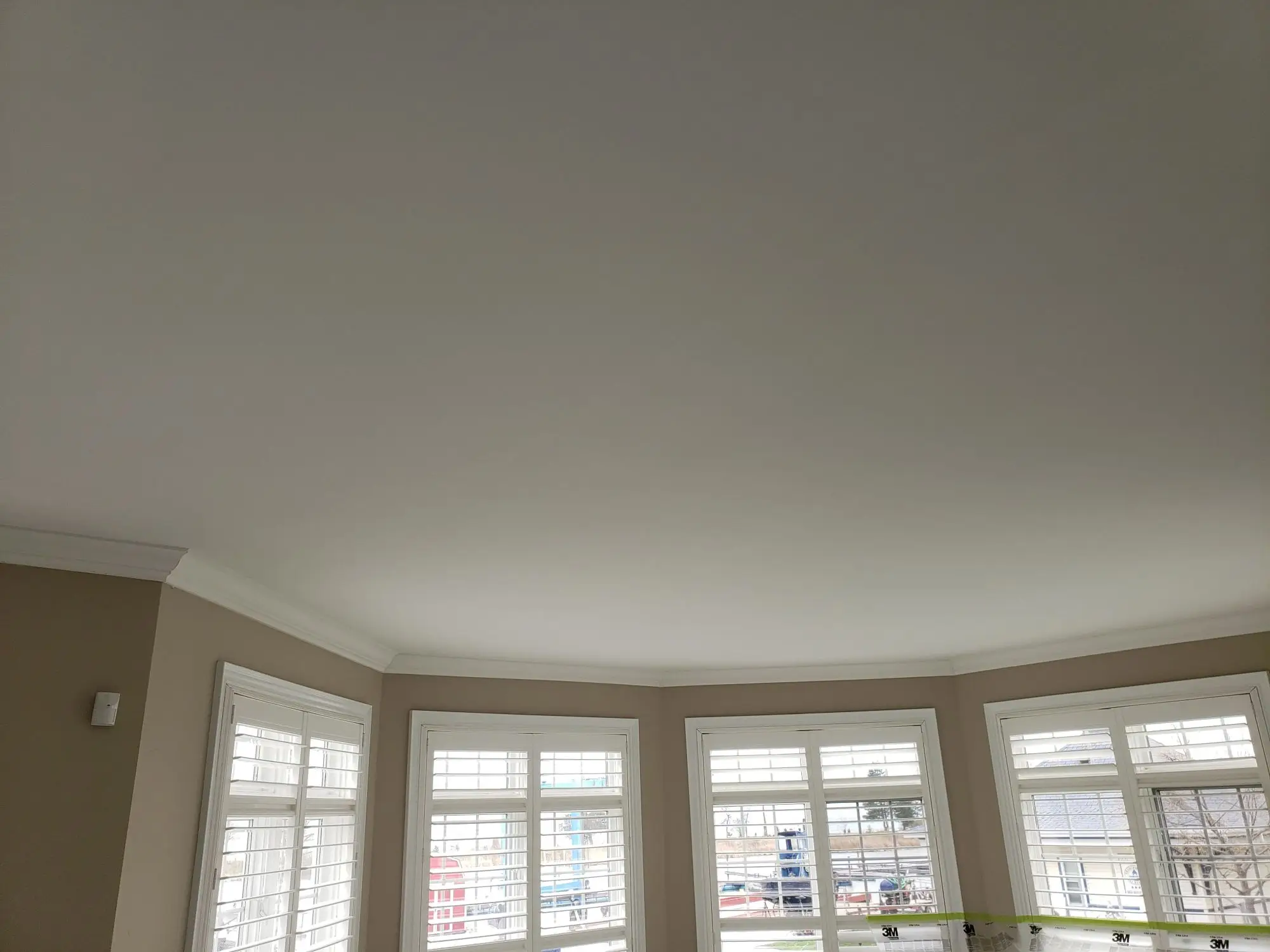 Smooth, newly resurfaced ceiling after professional popcorn ceiling removal and skim coating in Toronto.