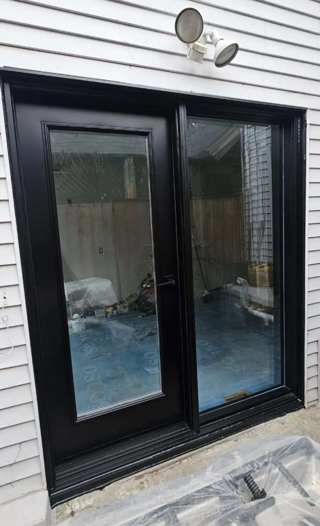 Sliding patio door installation bringing more light into a finished home.