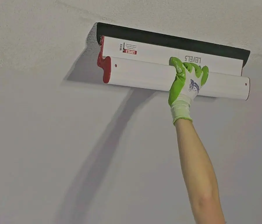 Wall repair and repaint in a high-end modern kitchen.