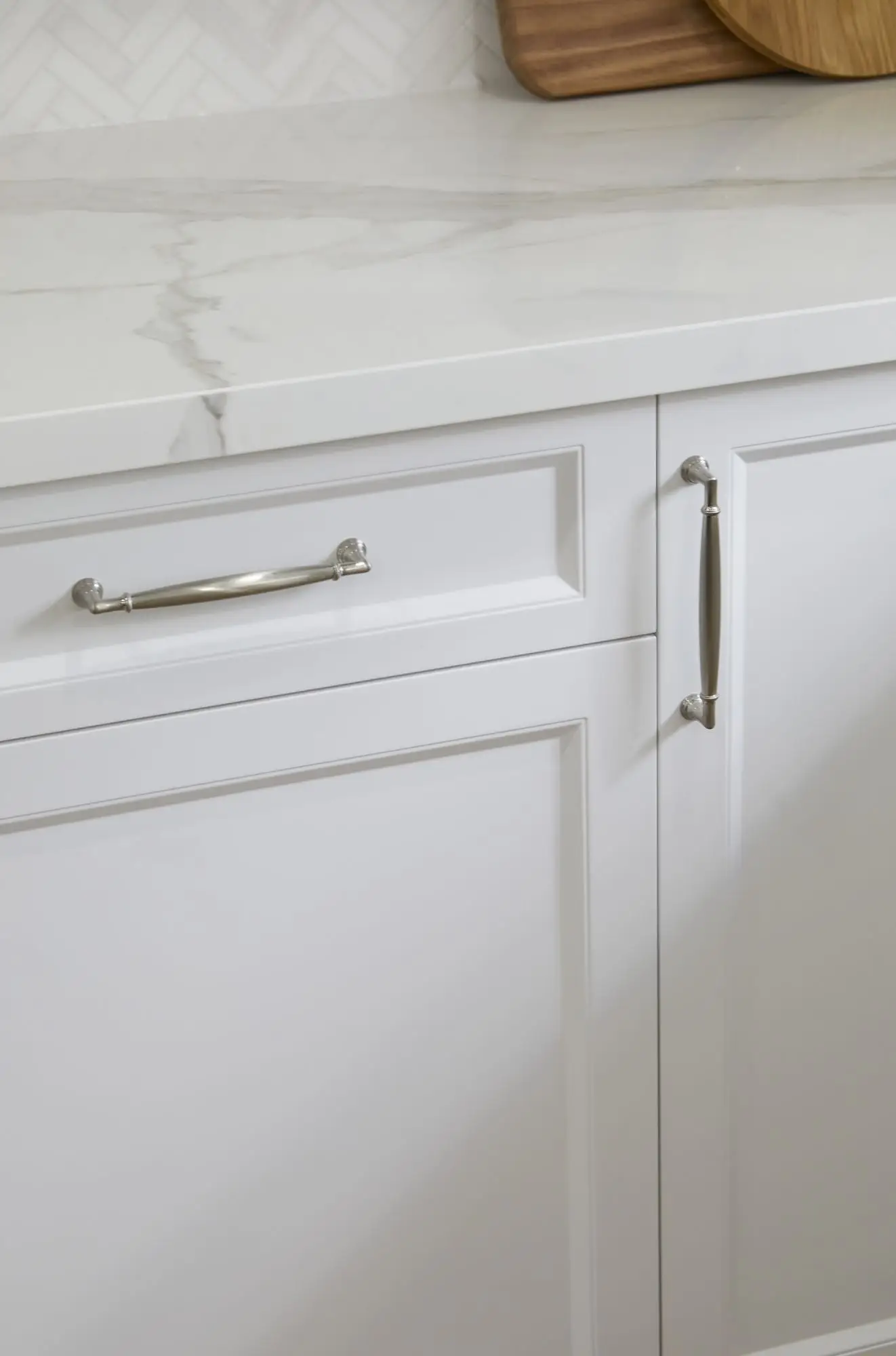 A warm wood-accent kitchen with stone backsplash and integrated lighting.