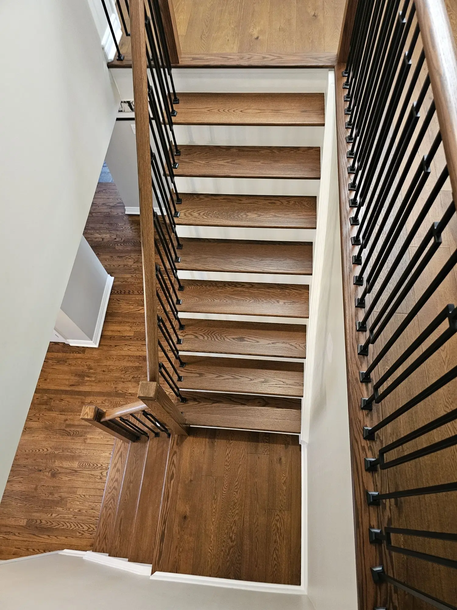 Modern staircase renovation in Vaughan with oak treads and updated finishes.