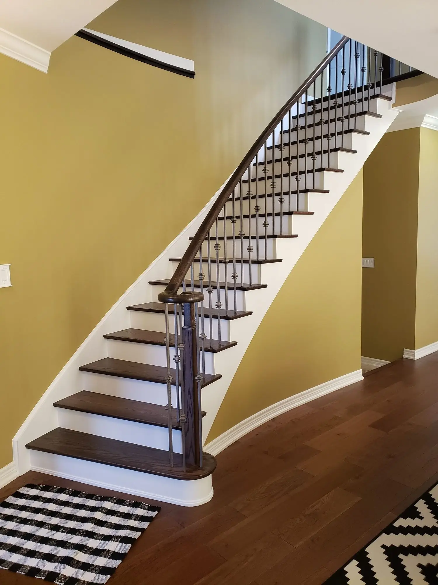 Stair railing repair in Richmond Hill with wood and iron components.