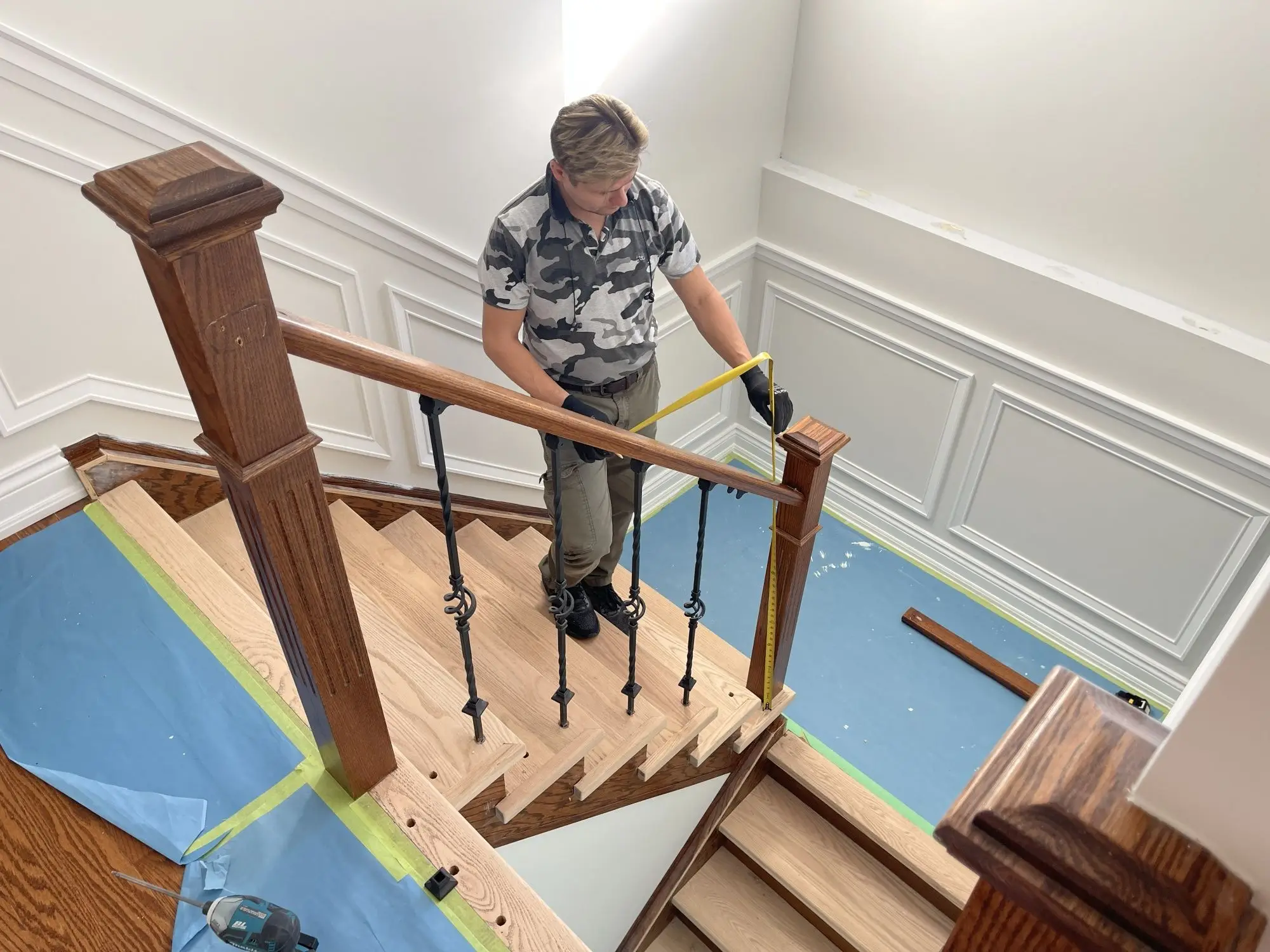 Carpet to hardwood stair conversion with oak tread caps and clean white risers.