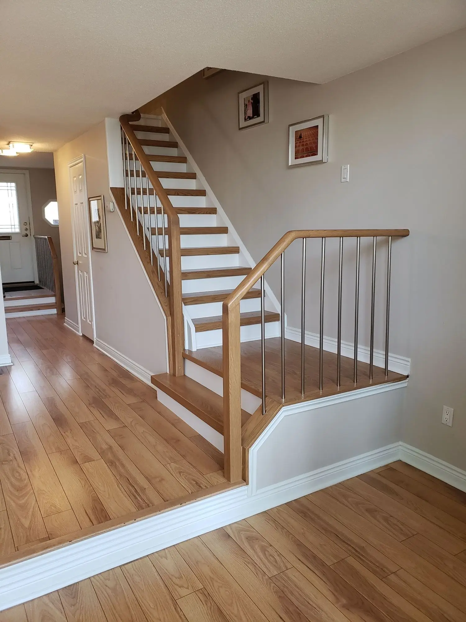 Hardwood stair tread cap installation in Toronto with oak and modern finish.