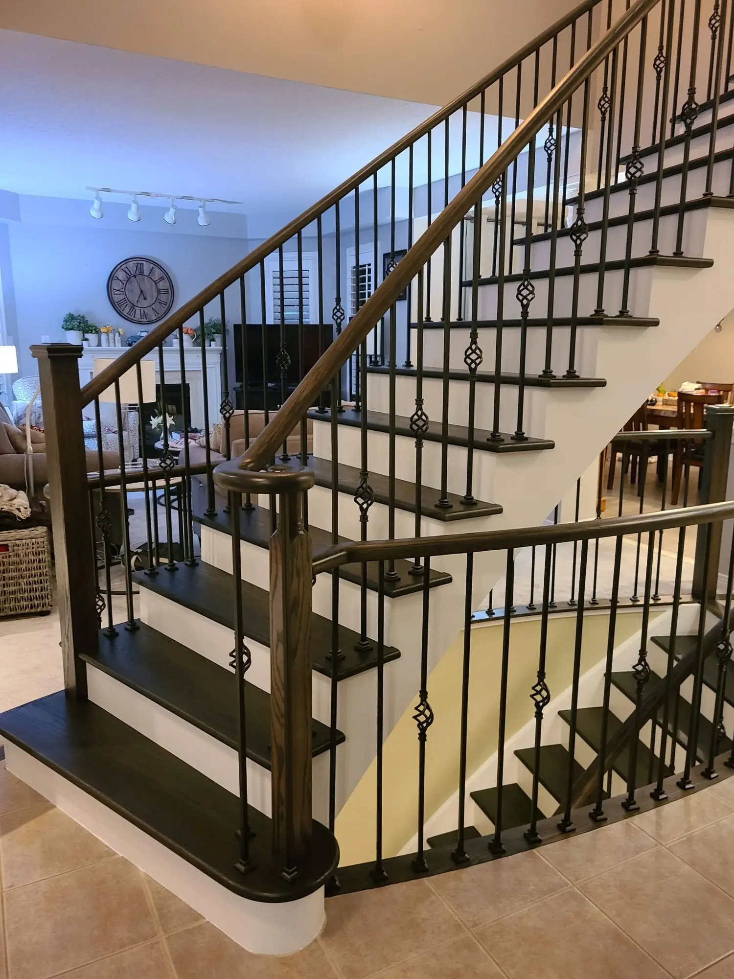 Staircase refinishing in Vaughan with black iron balusters.