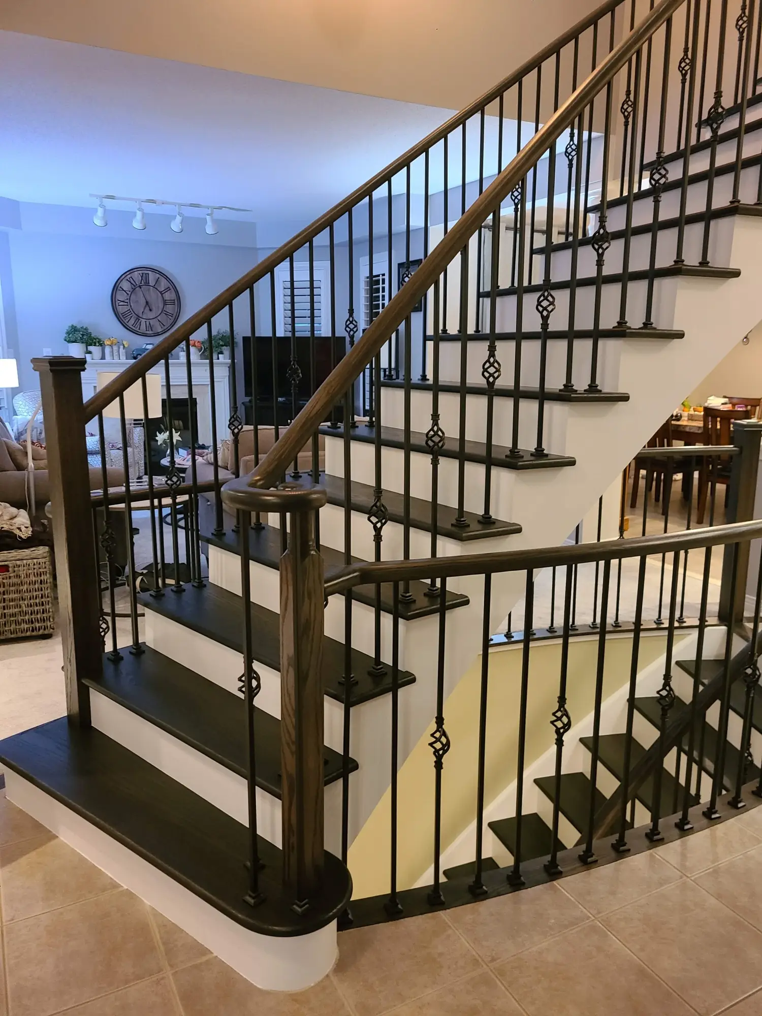 Staircase refinishing in Vaughan with black iron balusters.