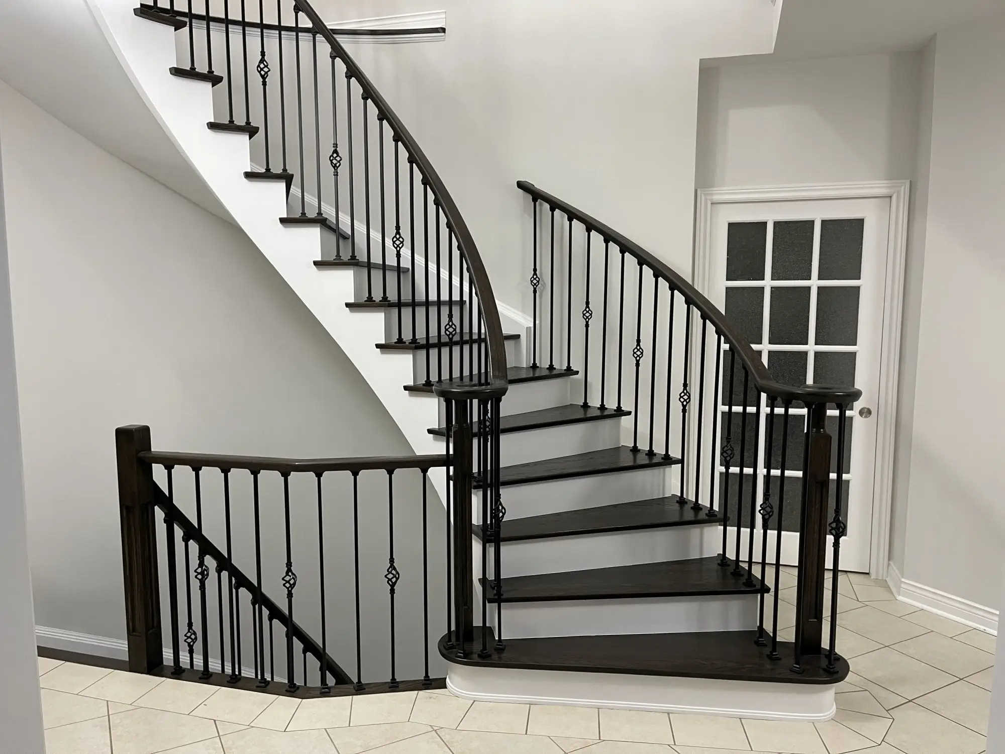 Staircase refinishing in Vaughan with white risers and hardwood treads.