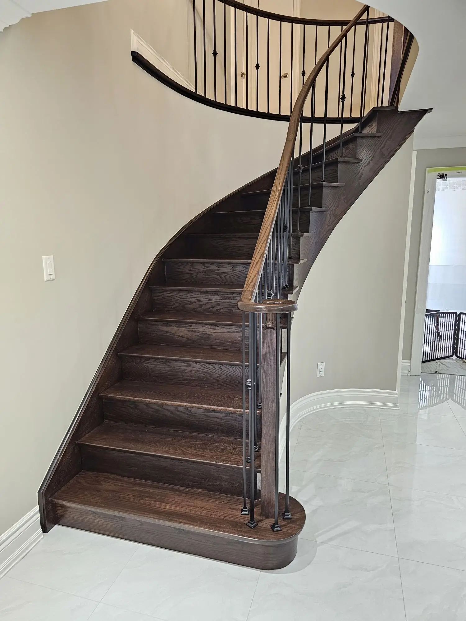 Curved staircase refinishing in Woodbridge with dark oak finish.