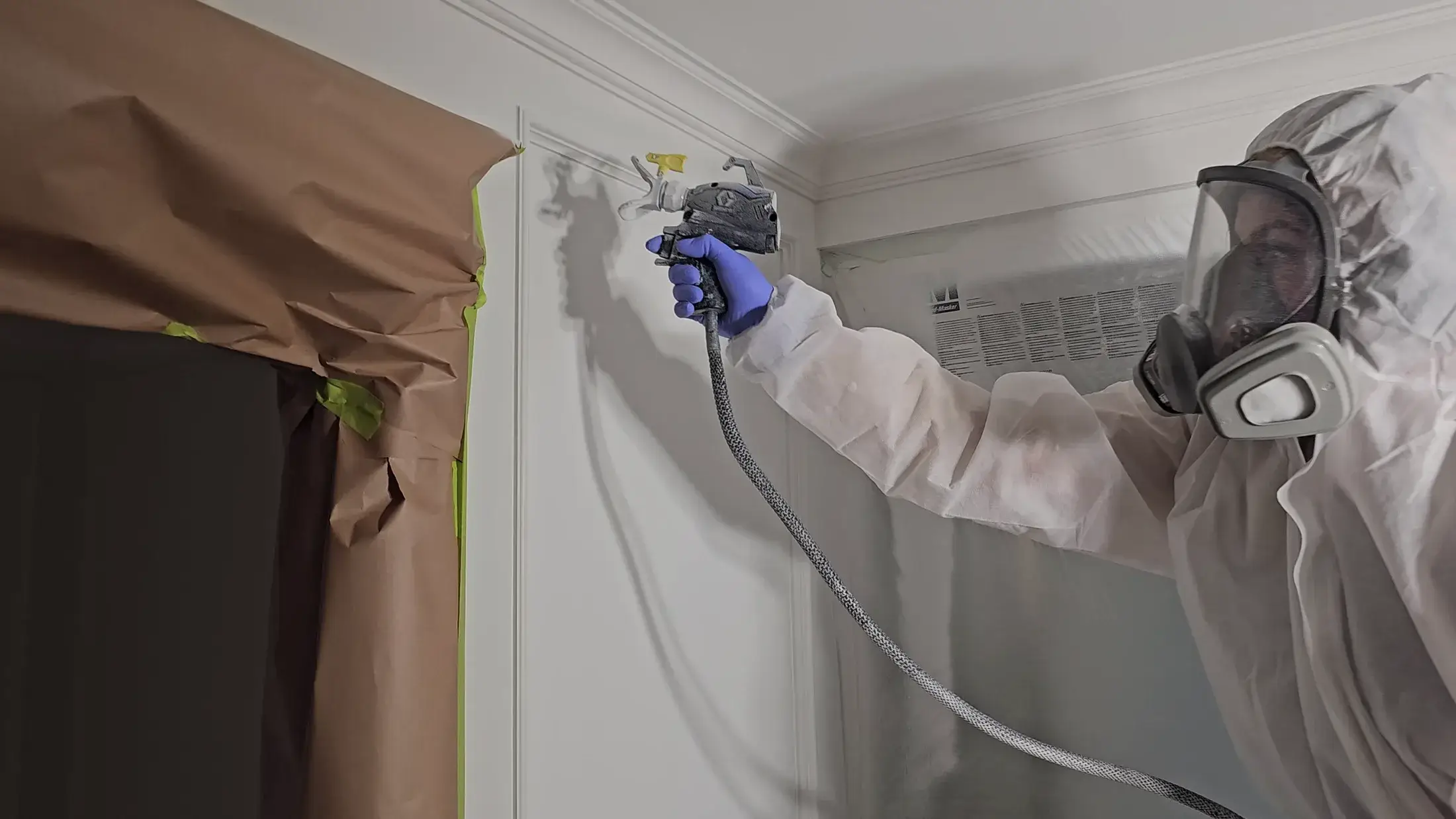 Wainscoting, doors, trim, and baseboard painting with a sprayed satin finish.