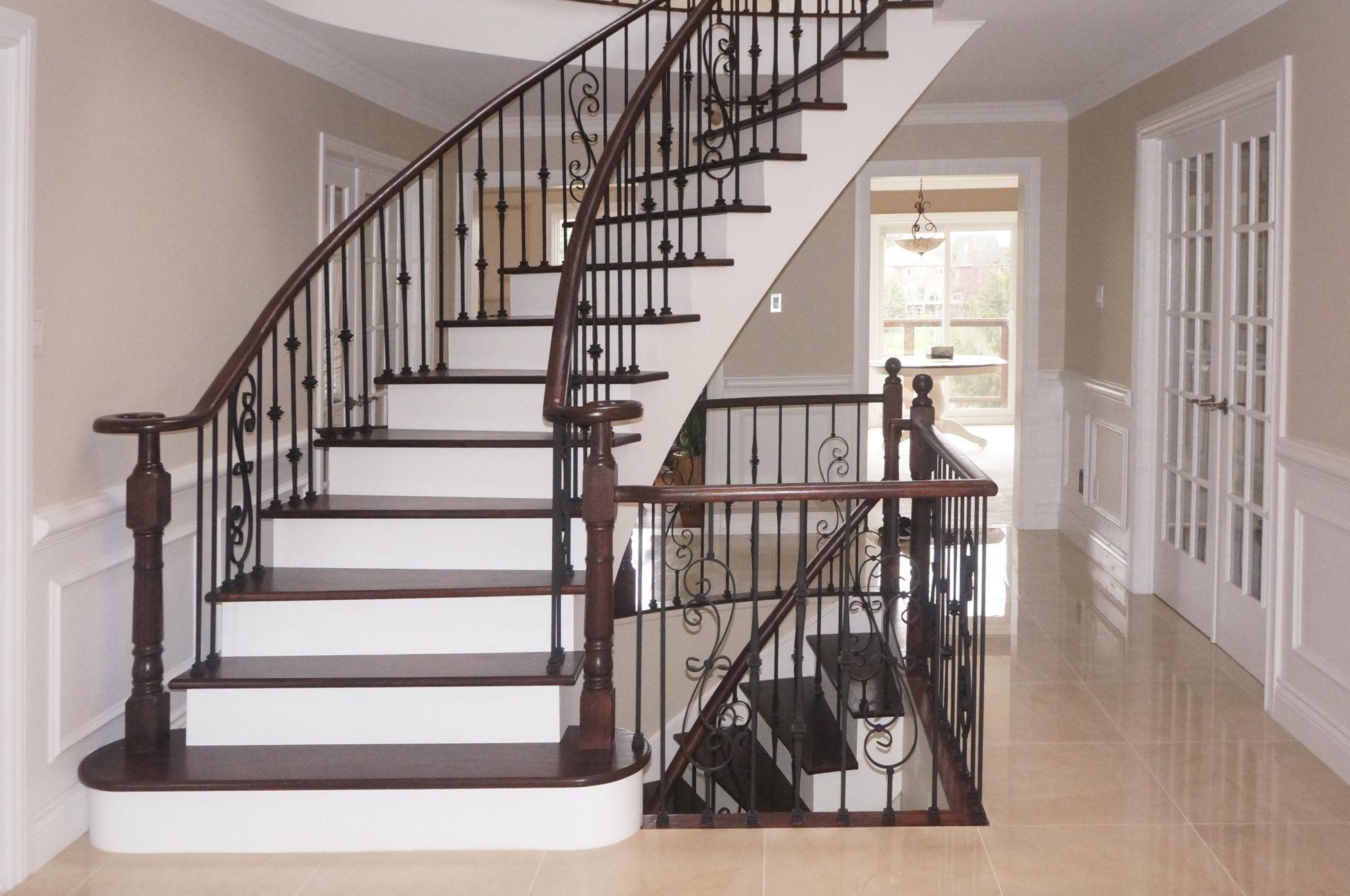 The same staircase after solid oak tread caps, white risers and an updated railing system.