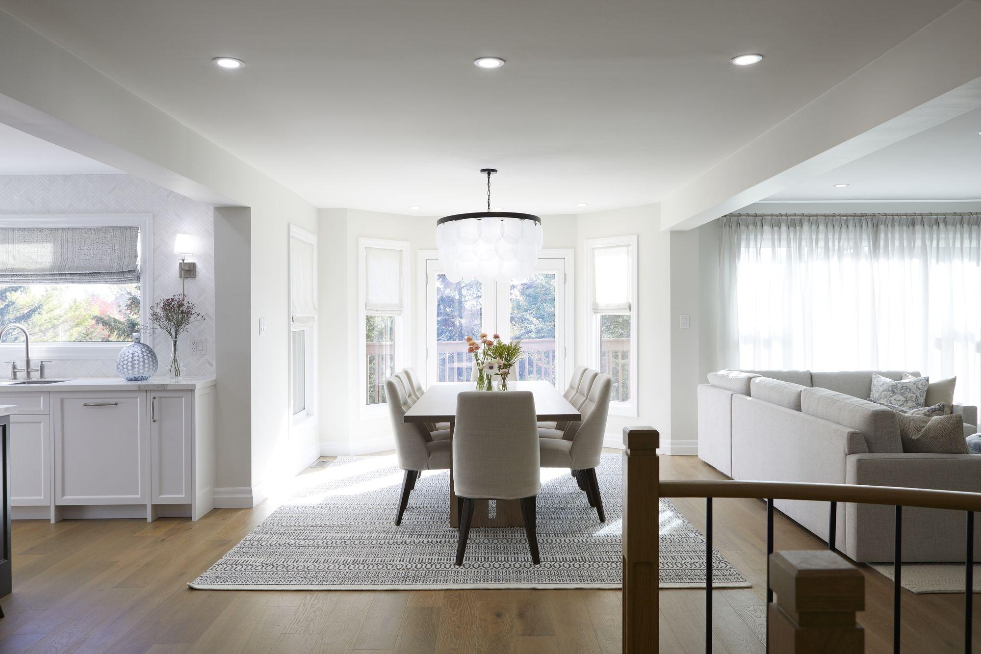 Connected Toronto interior renovation with coordinated dining, living and kitchen finishes.