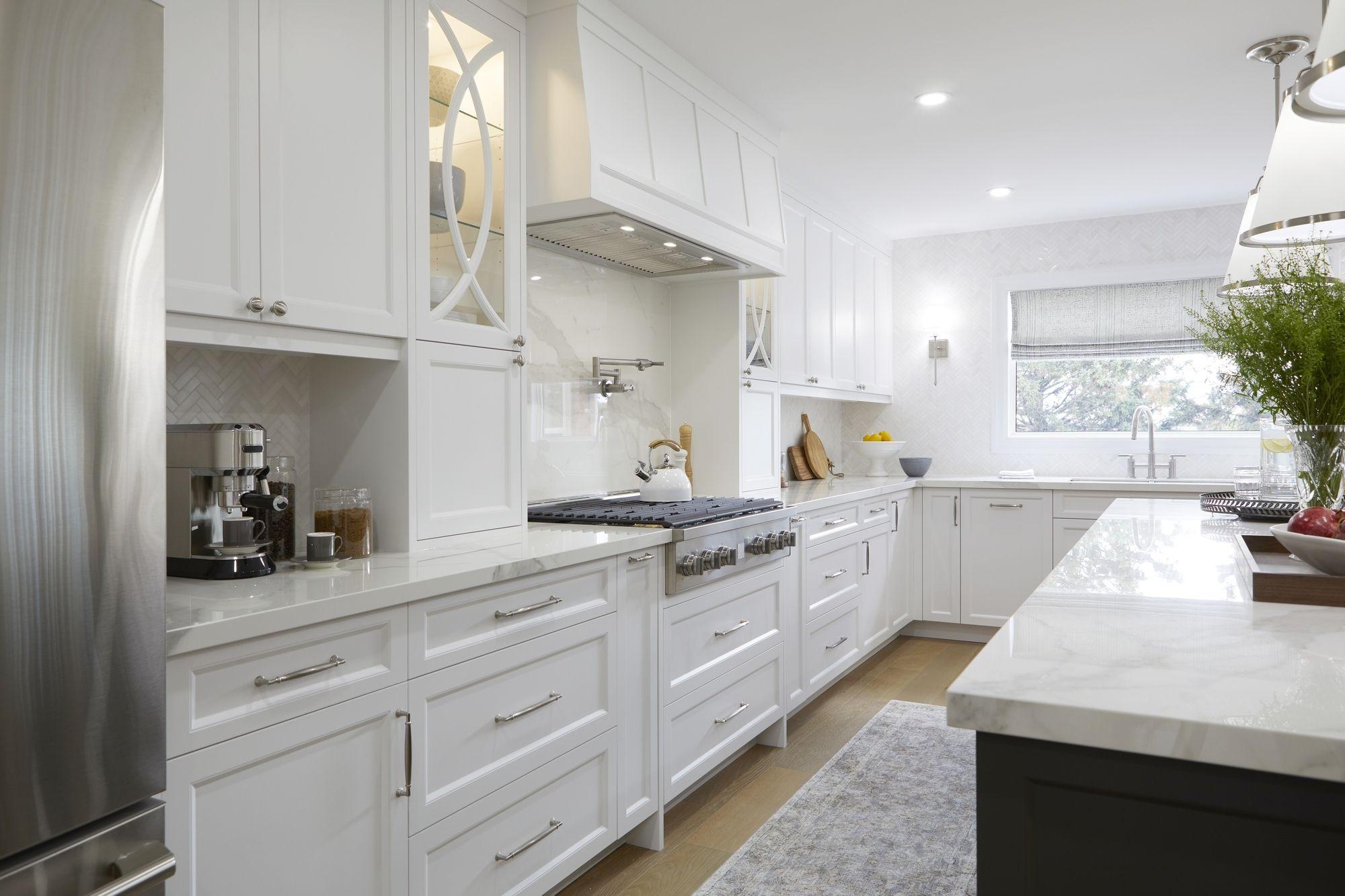 Modern Toronto kitchen renovation with white cabinetry and a central island.