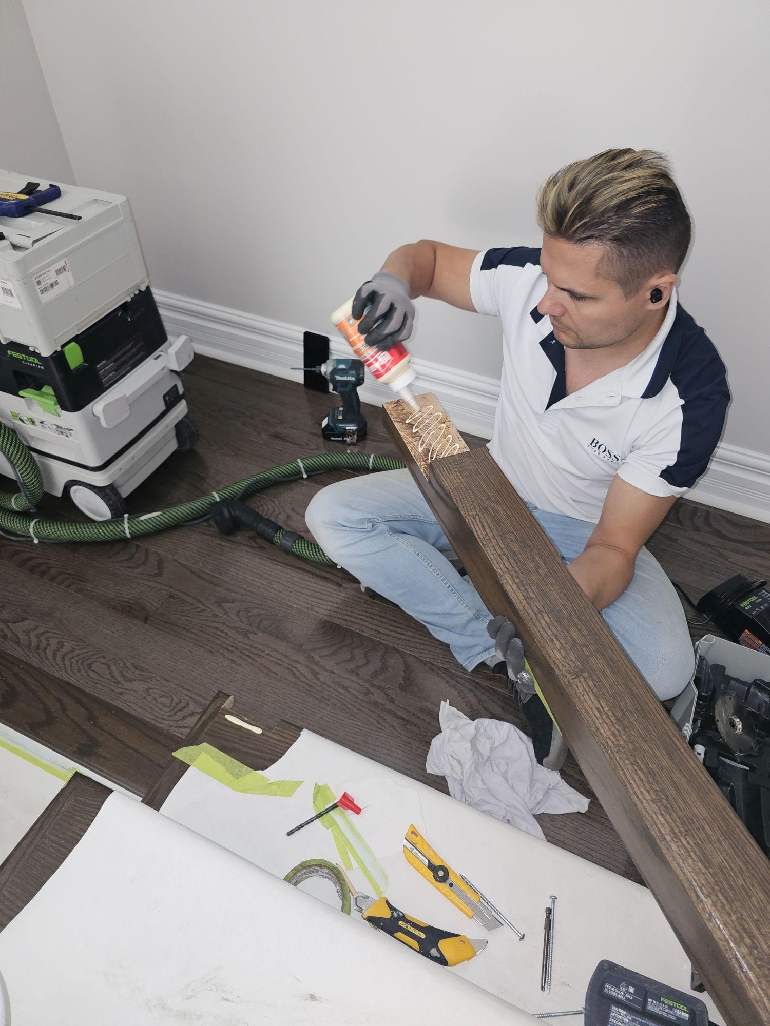 Maxim Sologub reviewing newel post installation details on a Strataline staircase project.