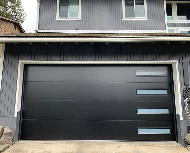 A full aluminum and glass garage door opening to a bright, spacious garage interior.