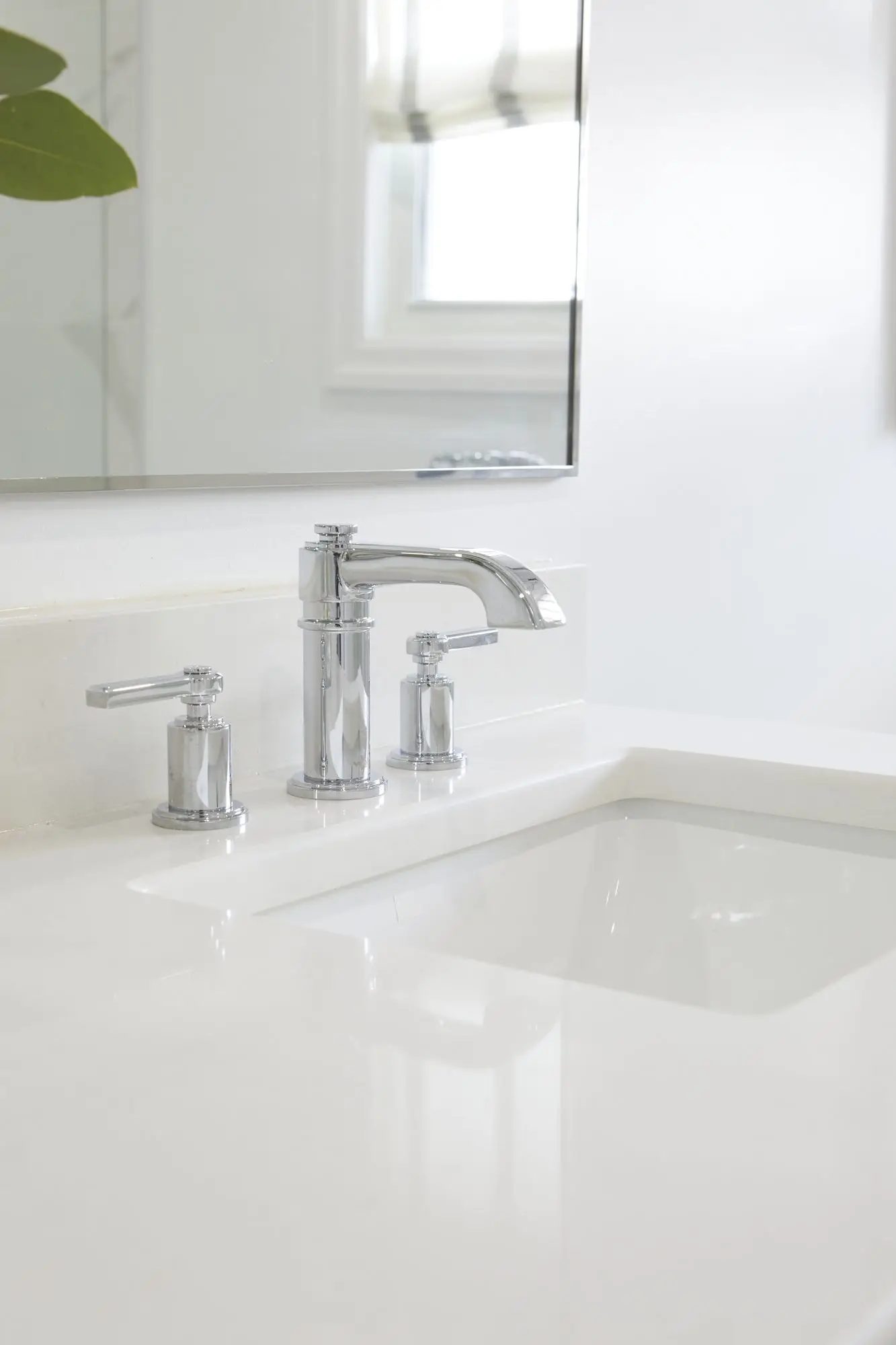 A stylish bathroom with a freestanding tub, wall-mounted faucet, and large windows for natural light.