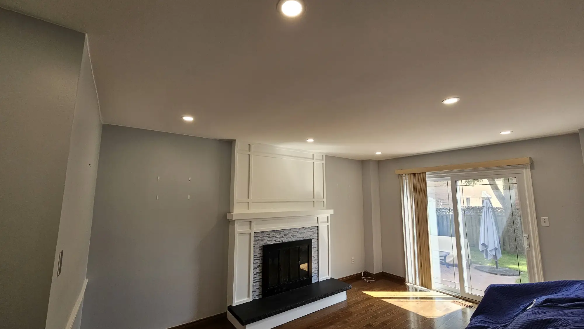 A living room with a textured popcorn ceiling, ready for a modern update or smooth refinishing.