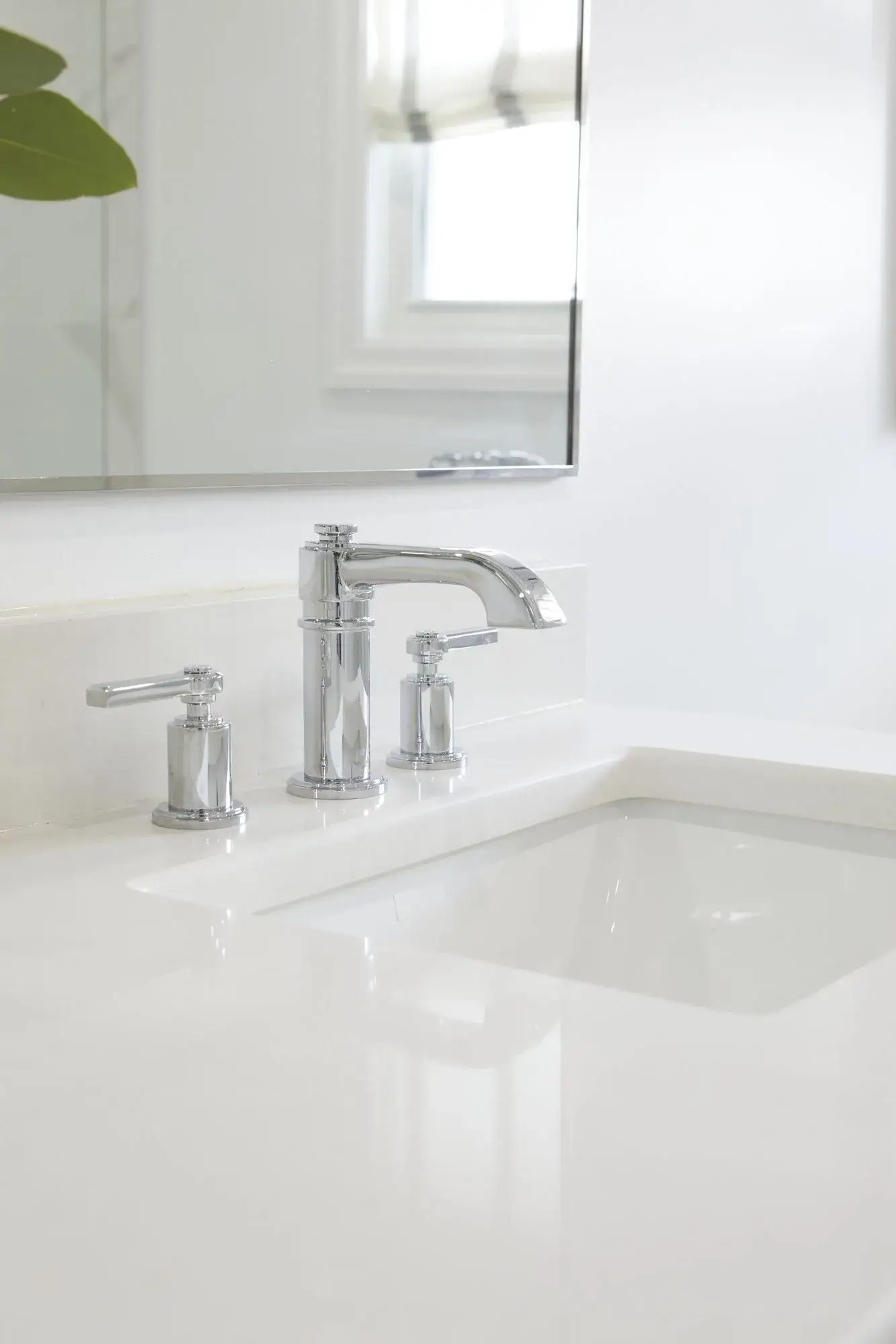 Chrome faucet and white countertop bathroom vanity detail with clean sink, soft natural light, and polished fixtures in Vaughan.