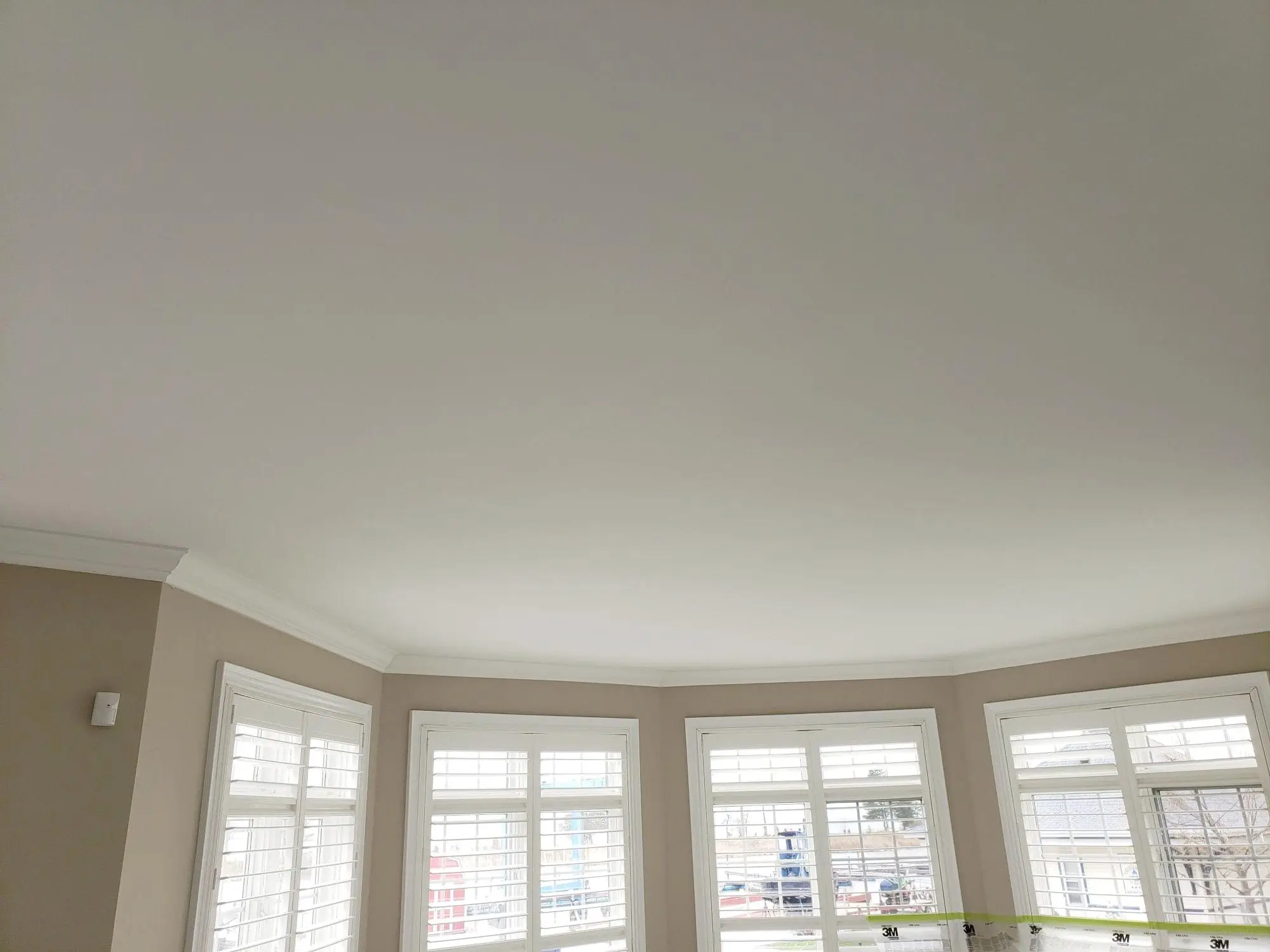 Smooth ceiling finishing after dust-controlled popcorn ceiling removal.