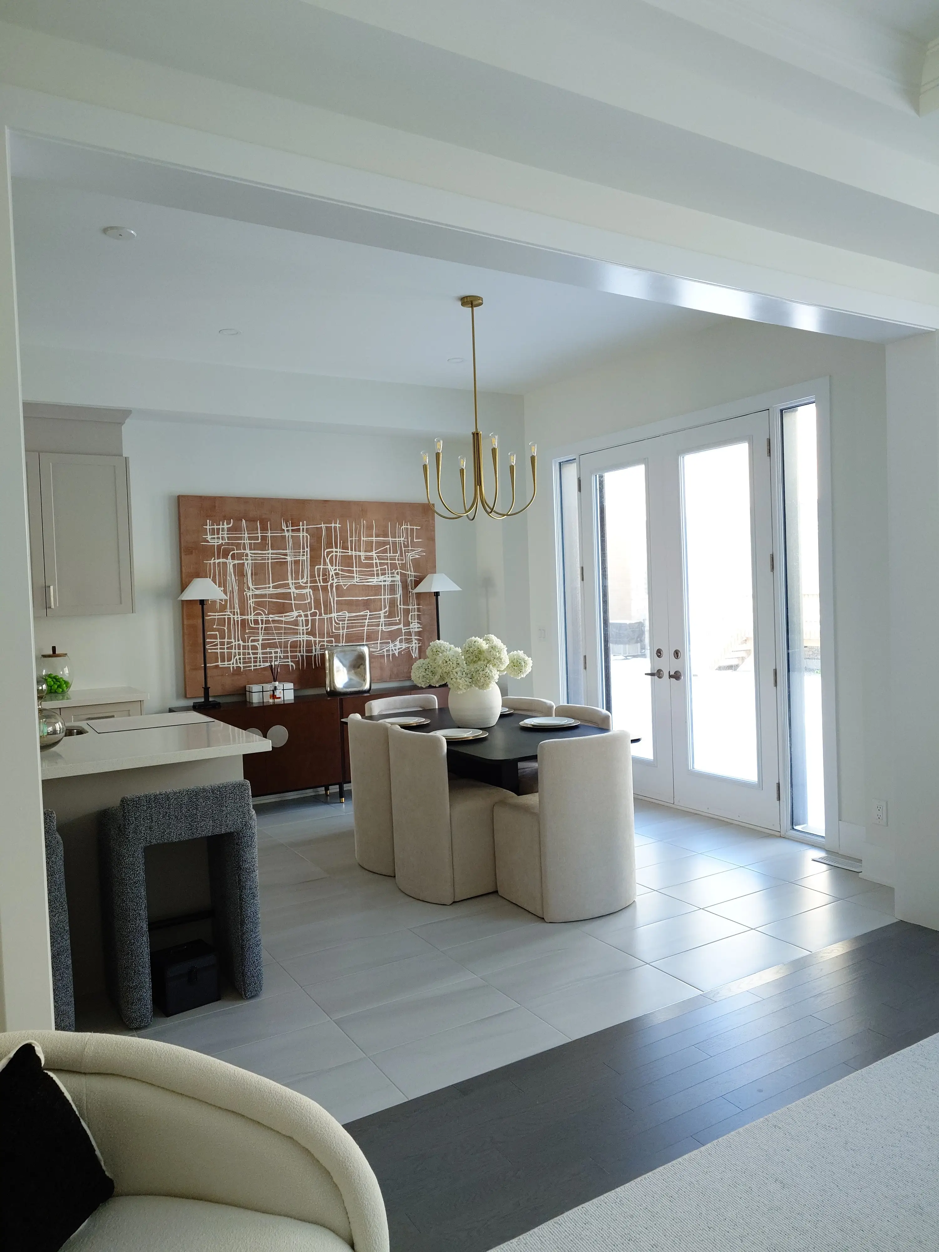 Wide plank flooring in a finished condo living room with bright windows and clean trim.