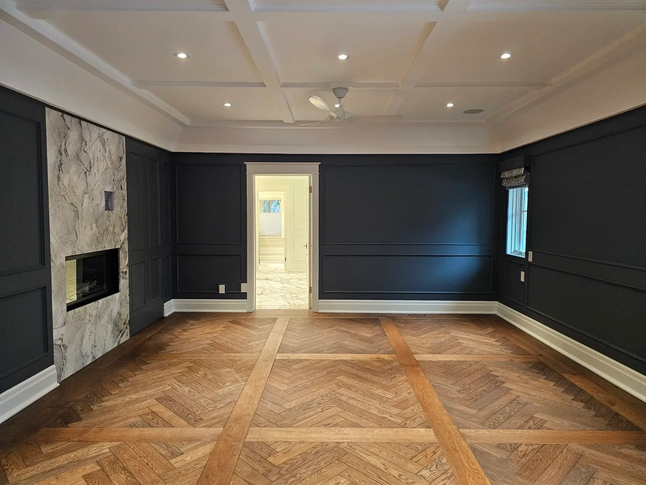 Finished dark feature wall painting with clean ceiling lines and detailed room preparation.