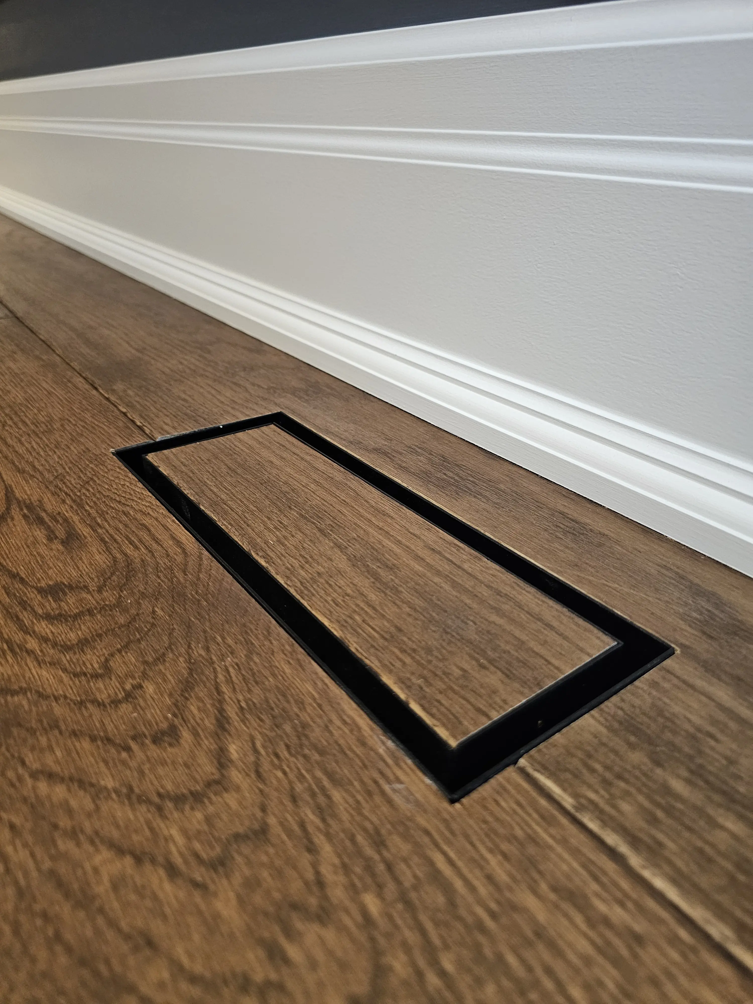 Flush floor register and hardwood flooring detail.