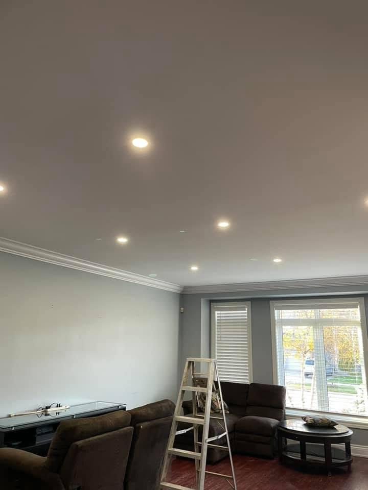 Finished living room with smooth ceilings and a coordinated recessed pot-light layout.