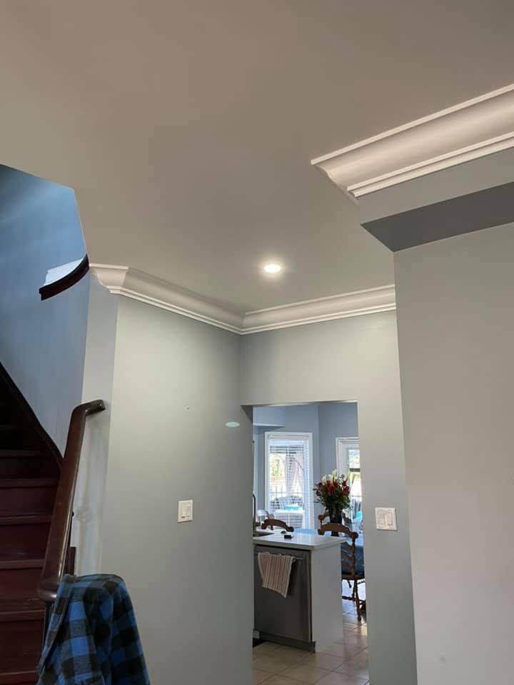 Finished smooth ceiling, crown moulding and hallway pot lights.