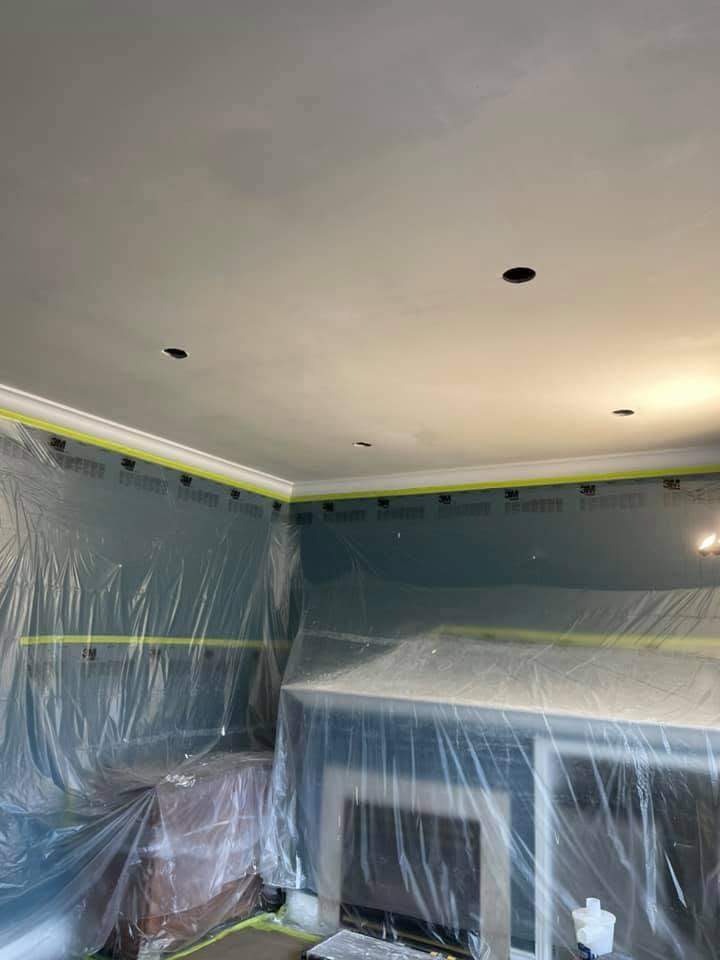 Skim-coated ceiling with pot-light openings ready for final finishing.