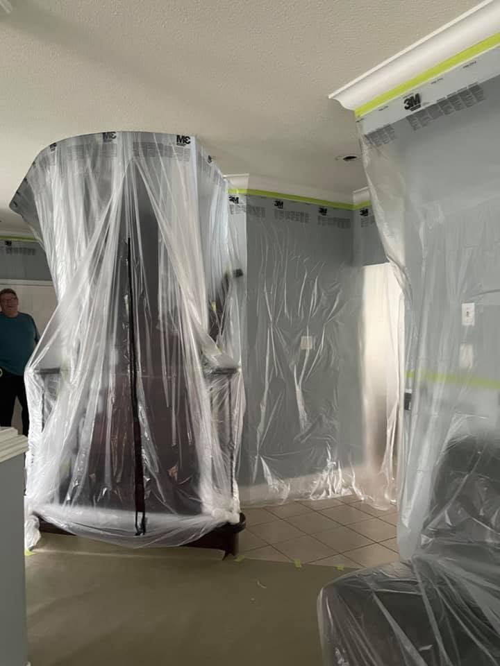 Staircase and columns protected during dust-controlled popcorn ceiling removal.