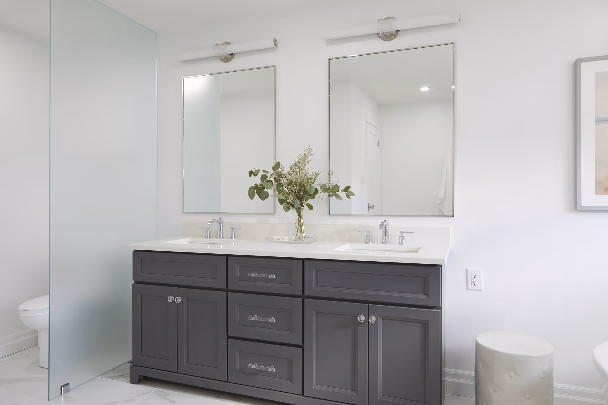 A renovated washroom with a bathtub and shower, bathed in soft natural light and adorned with stylish decor.