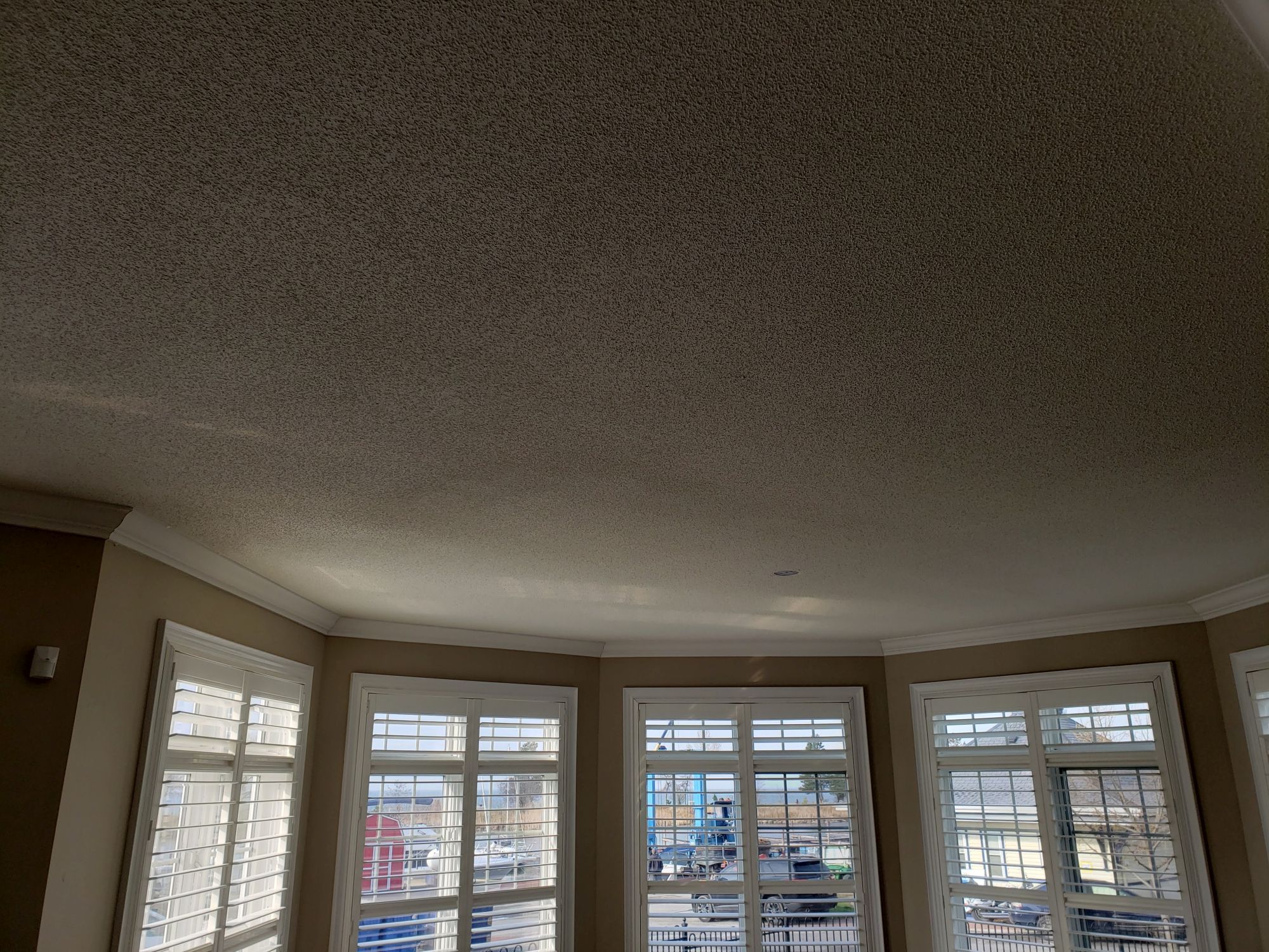 Popcorn ceiling removal around natural light before